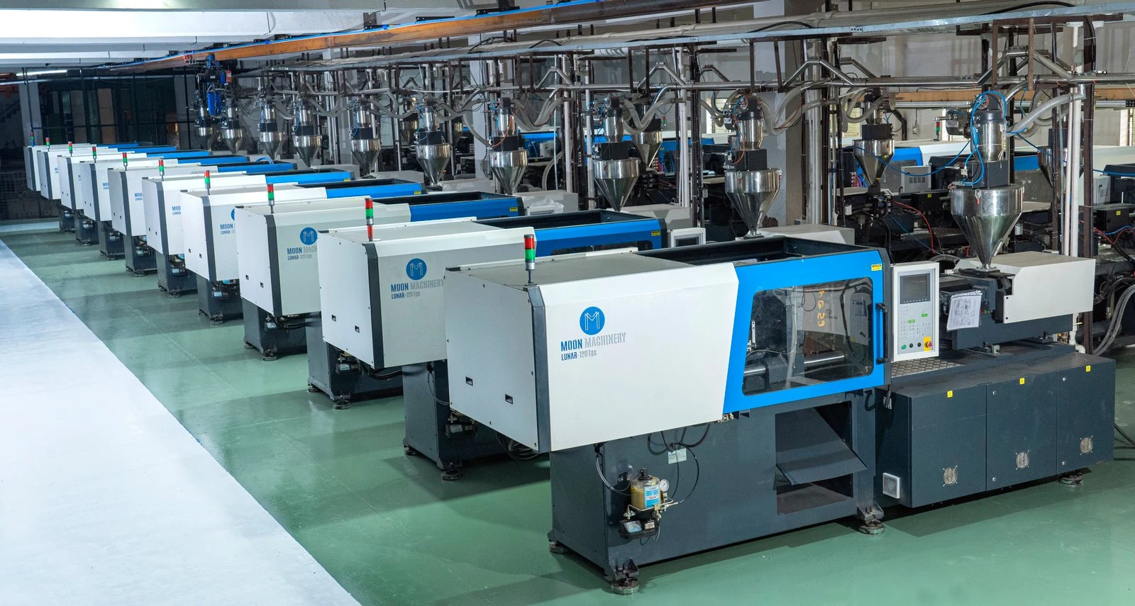 Blue and white Moon Machinery machines arranged on a production floor